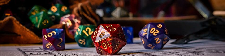 Polyhedral dice on a character sheet, a red twenty-sided die in the foreground.